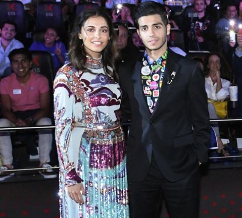 Mena Massoud Wearing A Suit In Mexico matched with a brightly patterned shirt underneath