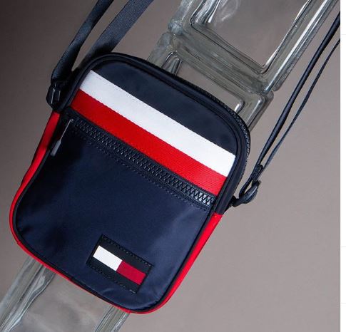 A blue, red and white Tommy Hilfiger bum bag