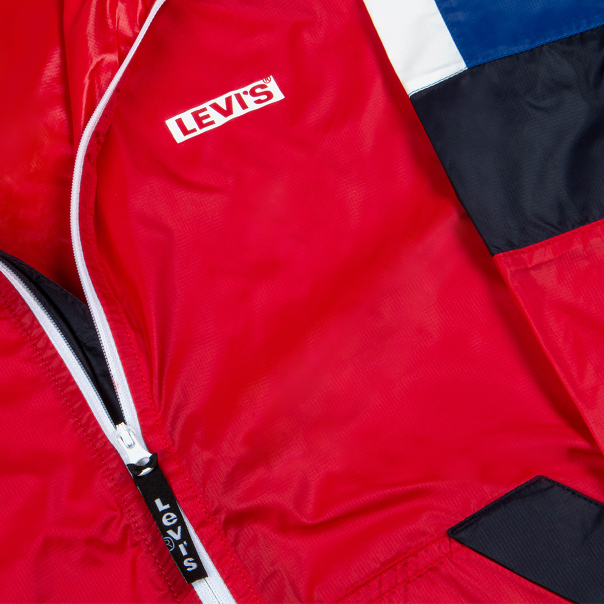 A bright red Levis' tracksuit top folded up neatly. 